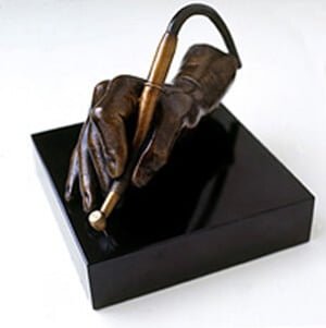 The Sculptor's Hand at work - bronze sculpture of a right hand holding a dentist's drill on a cable