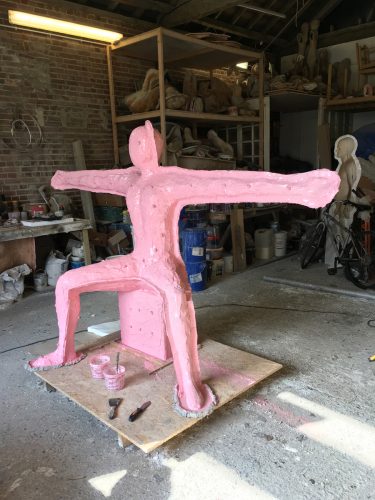 Moulding Speak to us of Giving. The model is encased in pink silicone to form the mould for casting the bronze sculpture.