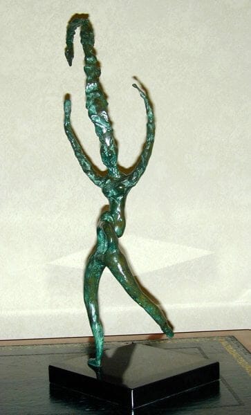 The Rites of Spring - a female figure dancing, arms upstretched and an exceptionally tall headdress which has bent over at the top under its own weight. Sculpture in Bronze.