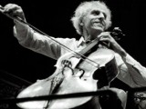 Paul Tortelier a black-and-white still from a masterclass. He is playing with a broad smile.