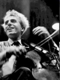 Paul Tortelier a black-and-white still from a masterclass. He is playing with a broad smile.