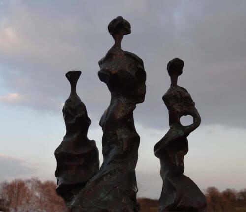 Three Sisters at dusk - semi-abstract bronze sculpture of three standing figures