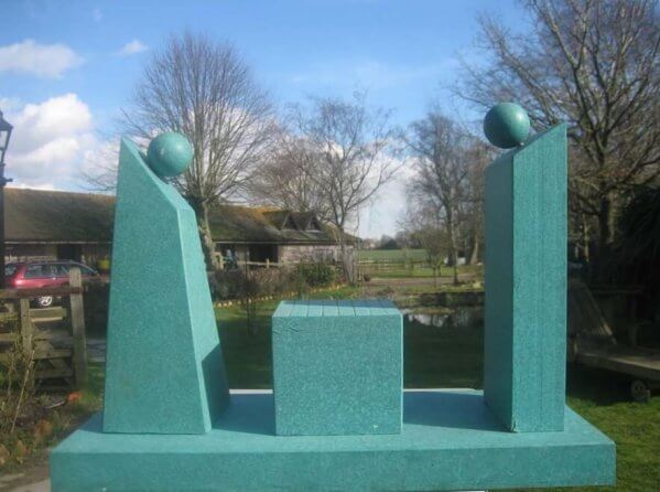 Stalemate - Sculpture of two semi-abstract figures facing one another across a chess board. Their heads are represented by plain balls.