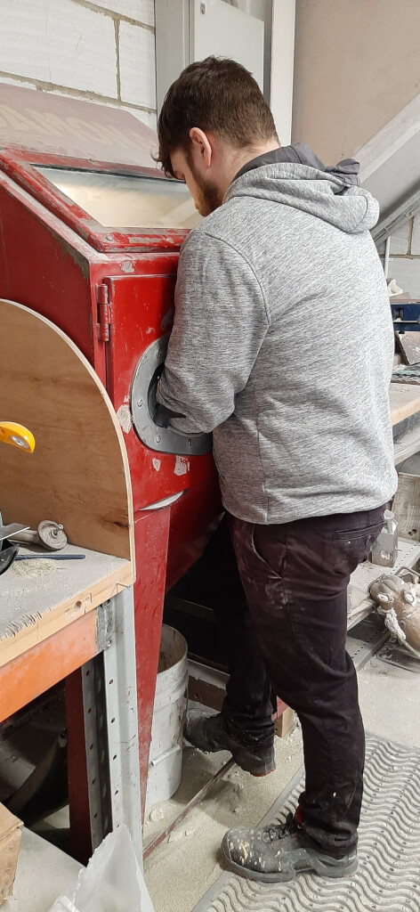 A casting getting a final clean to remove any last traces of the mould that may have been clinging to it.