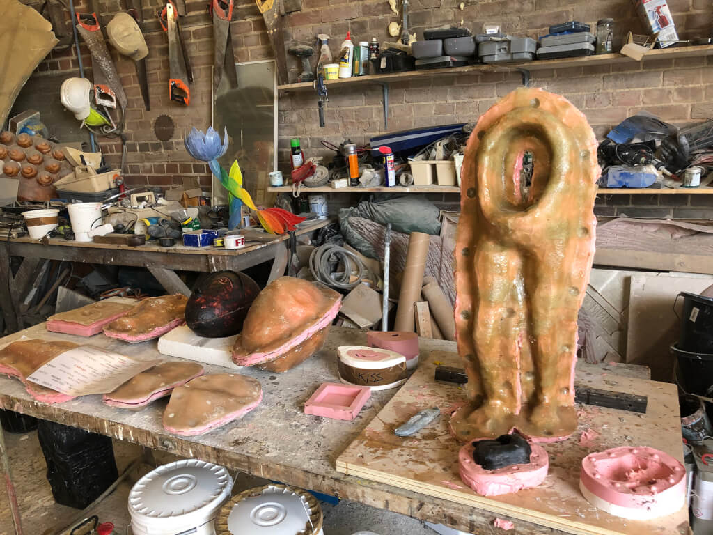 A collection of casting moulds on a workbench in the workshop.